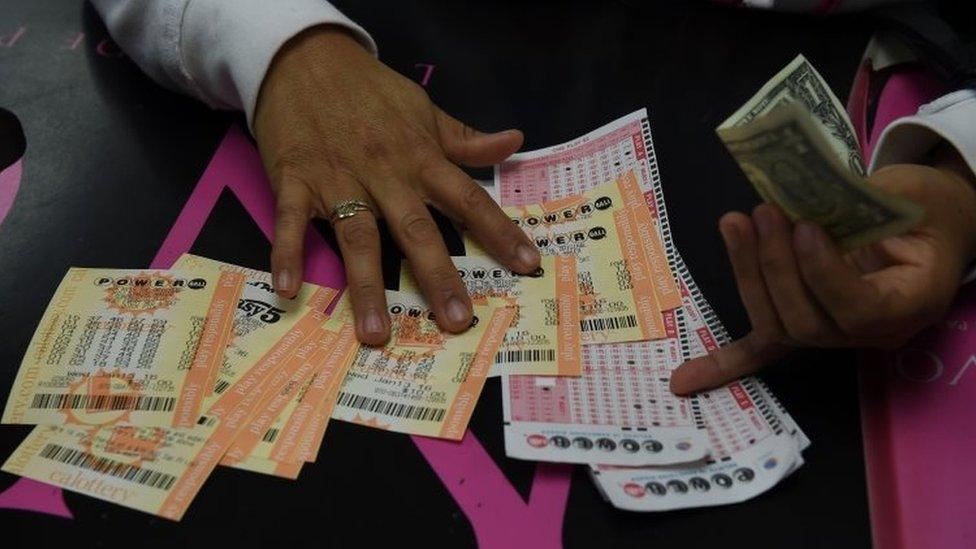 A woman picks up her Powerball lottery tickets in Hawthorne, California. Photo: 13 January 2015