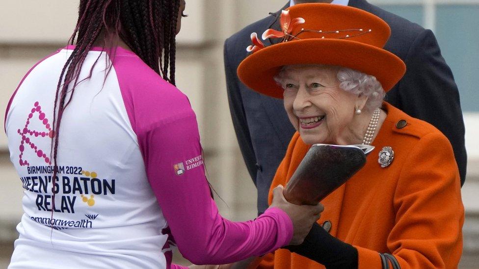 para-athlete kadeena cox receives the baton from queen elizabeth ii