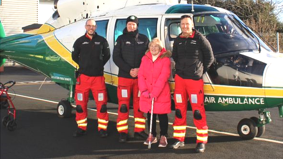 Carole Attle and medics stand in front of helicopter