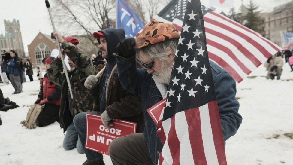 Supporters of President Donald Trump join in a mass prayer out front of the Michigan State Capitol Building to protest the certification of Joe Biden as the next president on January 6, 2021