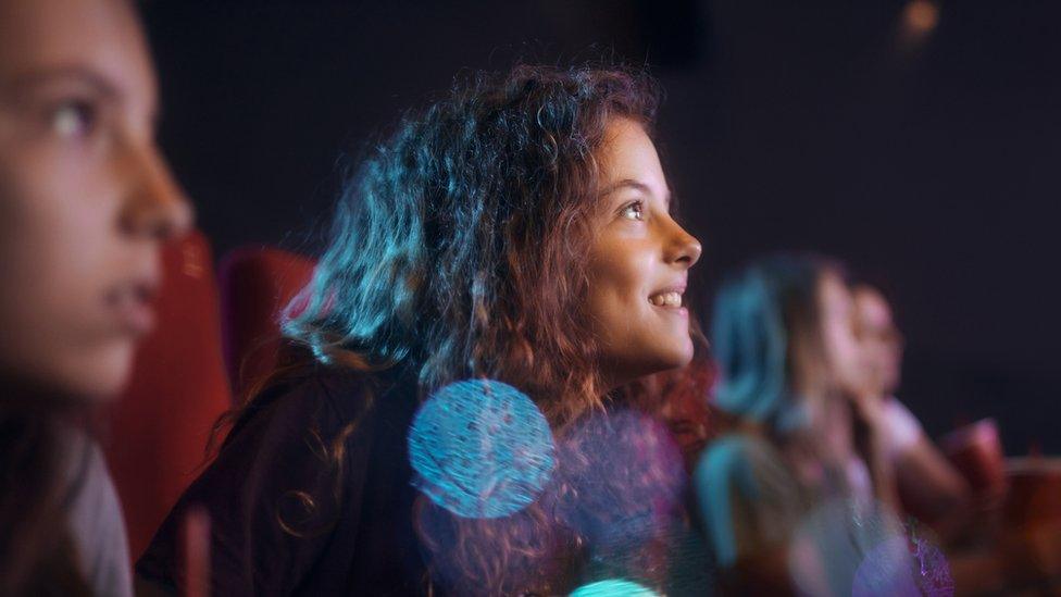 Teenagers watching a film at the cinema