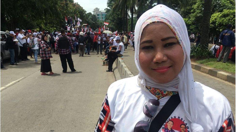 An Ahok supporter in a headscarf at a pro-Ahok rally