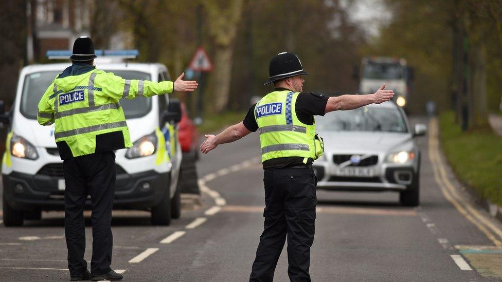 Police officers from North Yorkshire Police stop motorists in cars to check that their travel is "essential", in line with the British government's Covid-19 advice to "Stay at ˿", in York, northern England