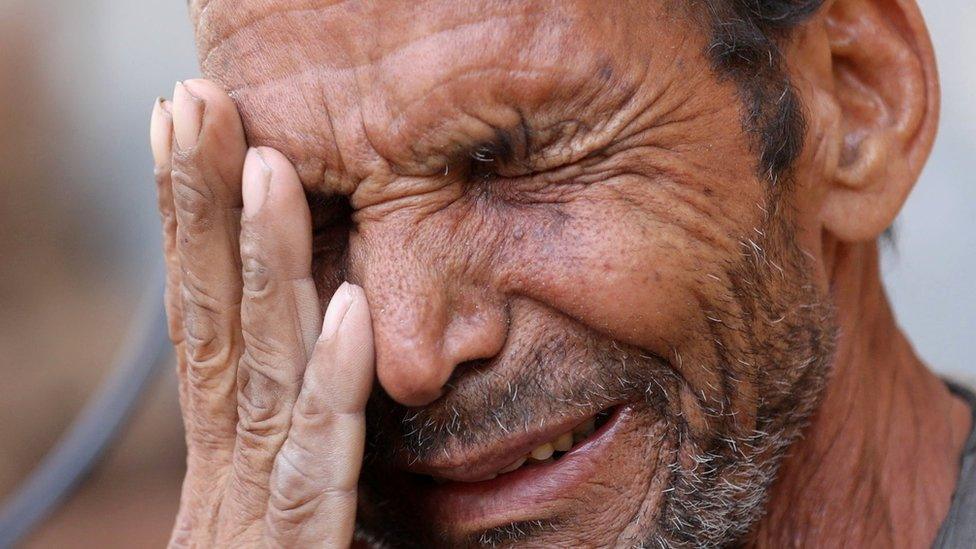 Hassan El Salheen, weeps after burying the repatriated body of his son, Aly,