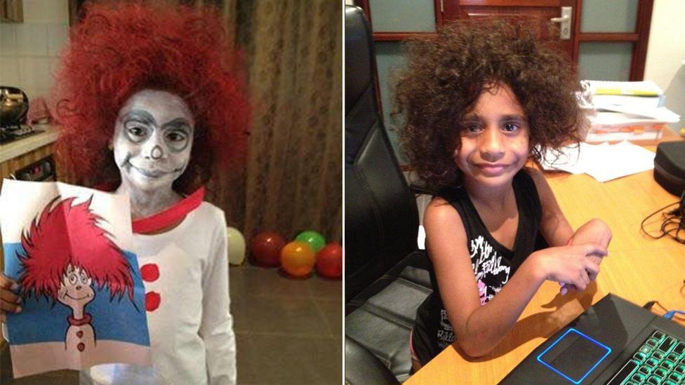 An Aboriginal girl with her face painted white for a school costume