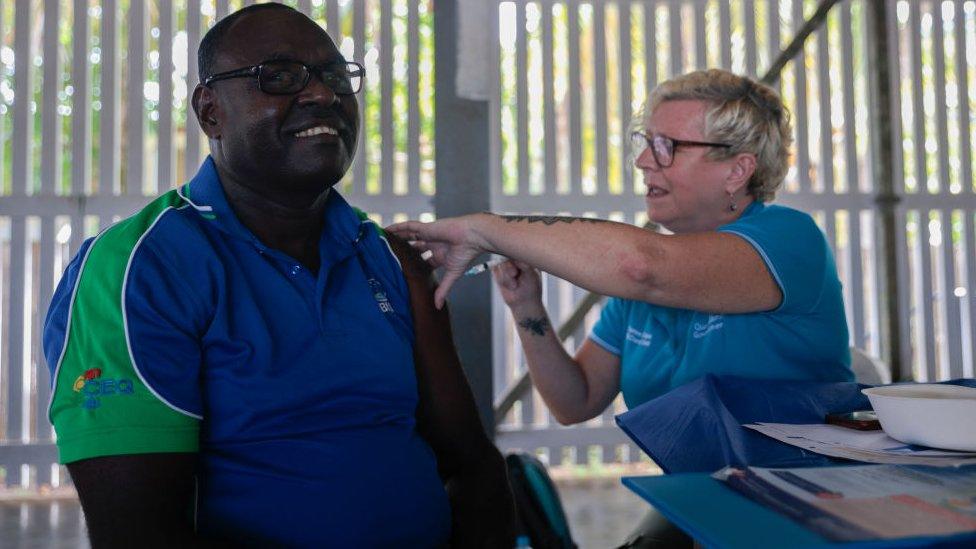 A man receives a jab in Boigu Island, in Australia's Torres Strait