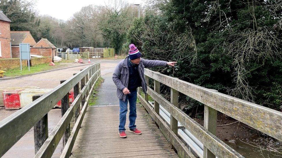 Will Laughton pointing at river