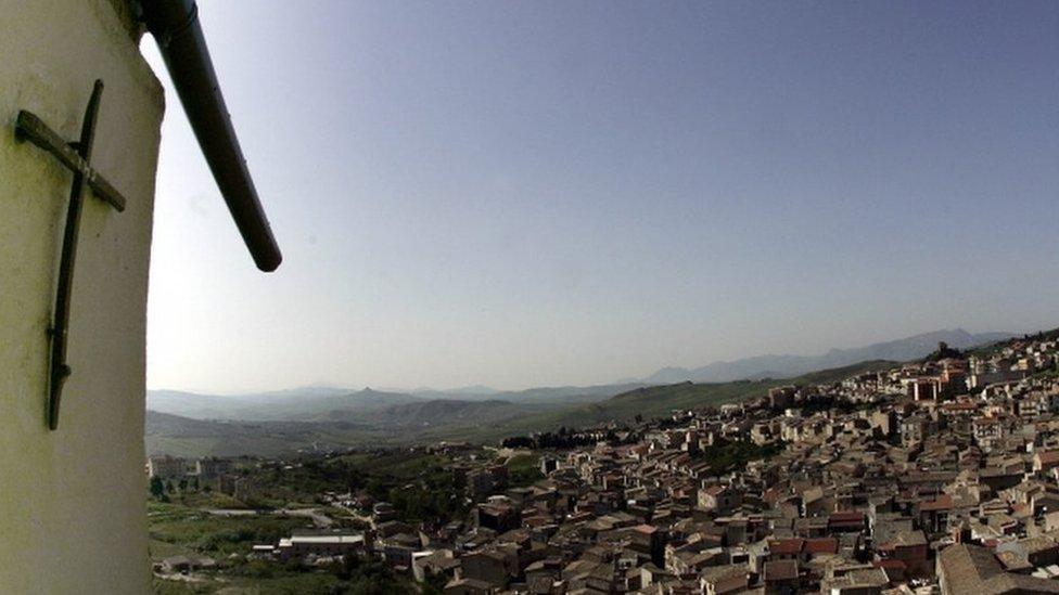 A crucifix towers over Corleone, Italy, the ancestral home and surname of the title characters in The Godfather novel and films