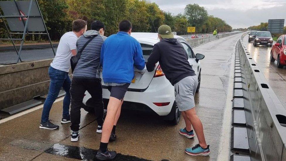 car being pushed along A11 roadworks