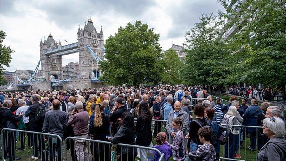 People queueing outside London Bridge, with barriers around them