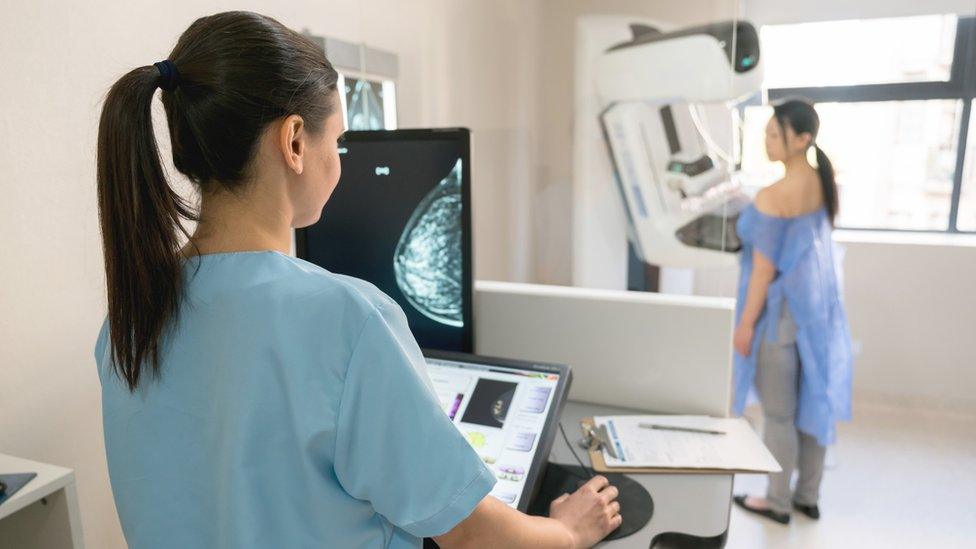 A woman having a mammogram