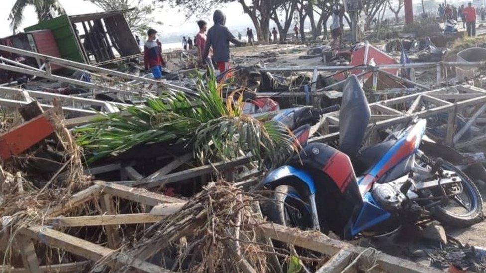 People walk among debris in Palu. Photo: 29 September 2018