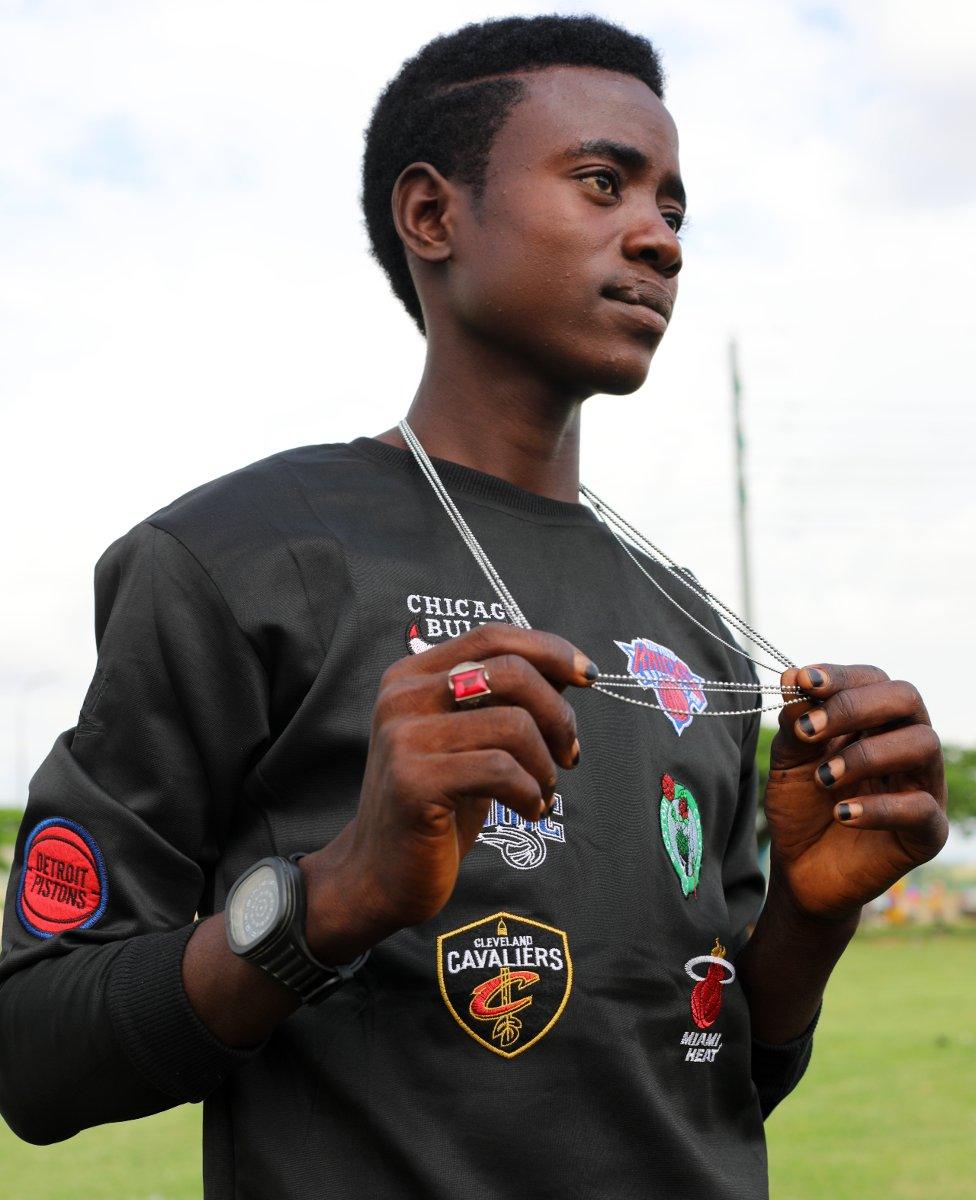 Fulani man holding out his chain