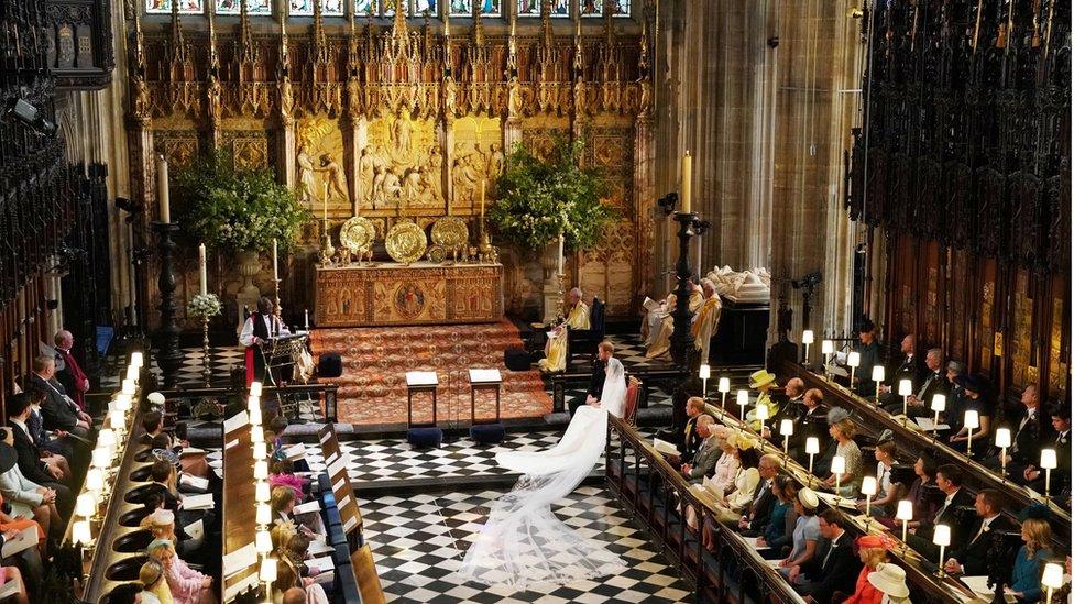 Prince Harry and Meghan Markle listen to an address by the Most Rev Bishop Michael Curry, primate of the Episcopal Church, in St George's Chapel at Windsor Castle during their wedding service in Windsor, Britain, May 19, 2018