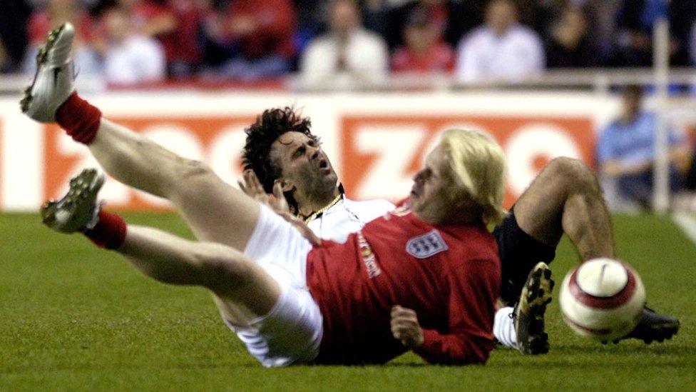 England's Boris Johnson (bottom) tackles Germany's Maurizio Gaudino during the Legends match at the Madejski Stadium in Reading