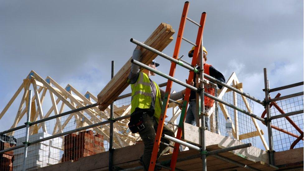 Builders working on a house