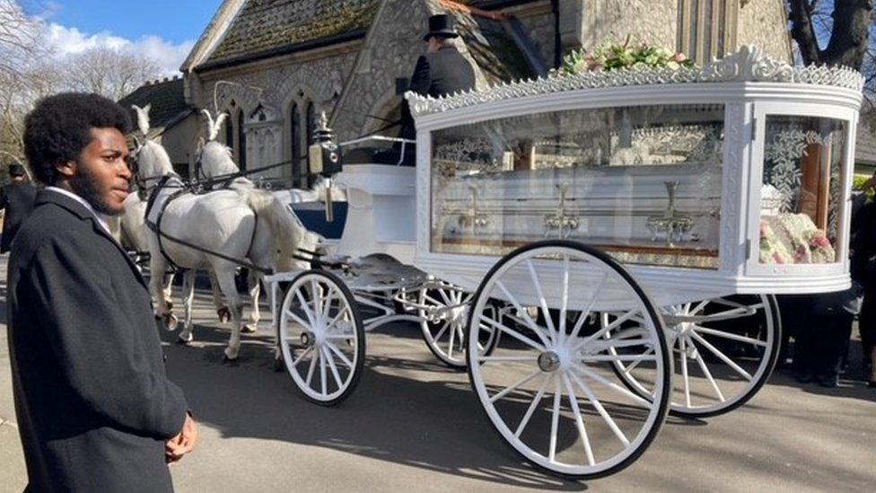 Ms Ikumelo's coffin arrived in a carriage led by white horses