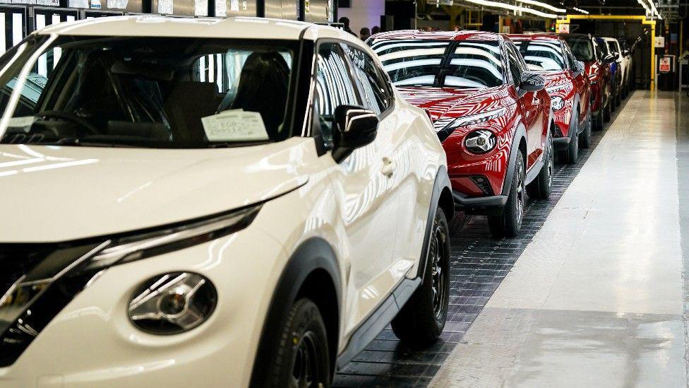 A row of new white and red electric Nissan cars at its factory in Sunderland