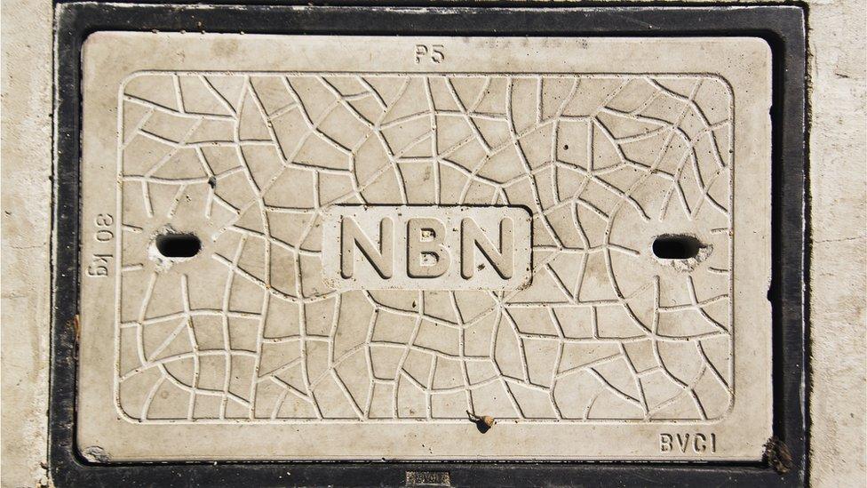 A signs in concrete says "NBN"