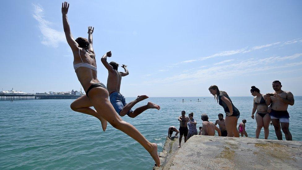 People leaping into the sea in Brighton