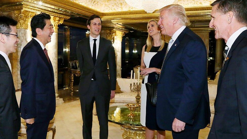 Japanese Prime Minister Shinzo Abe (2nd L) being welcomed by US President Donald Trump. Michael Flynn is on the right