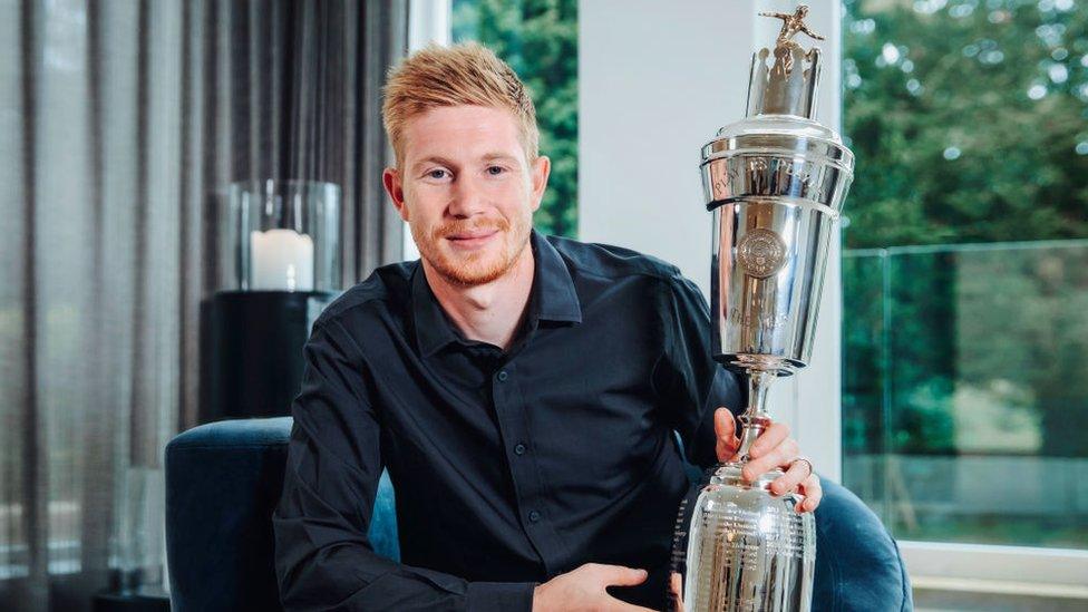 Kevin de Bruyne holding the Player of the Year trophy