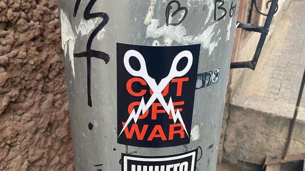 Cut off War poster on lamp post in St Petersburg, Russia