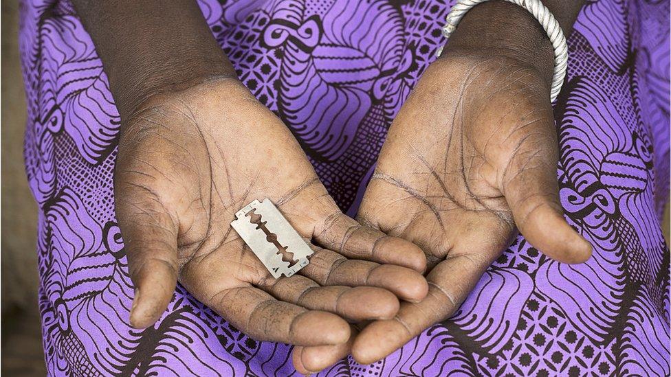 Woman holds FGM cutting tool