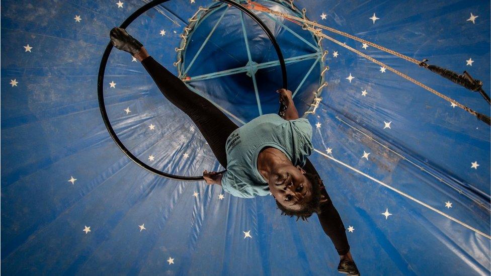 Woman in a suspended acrobat ring.