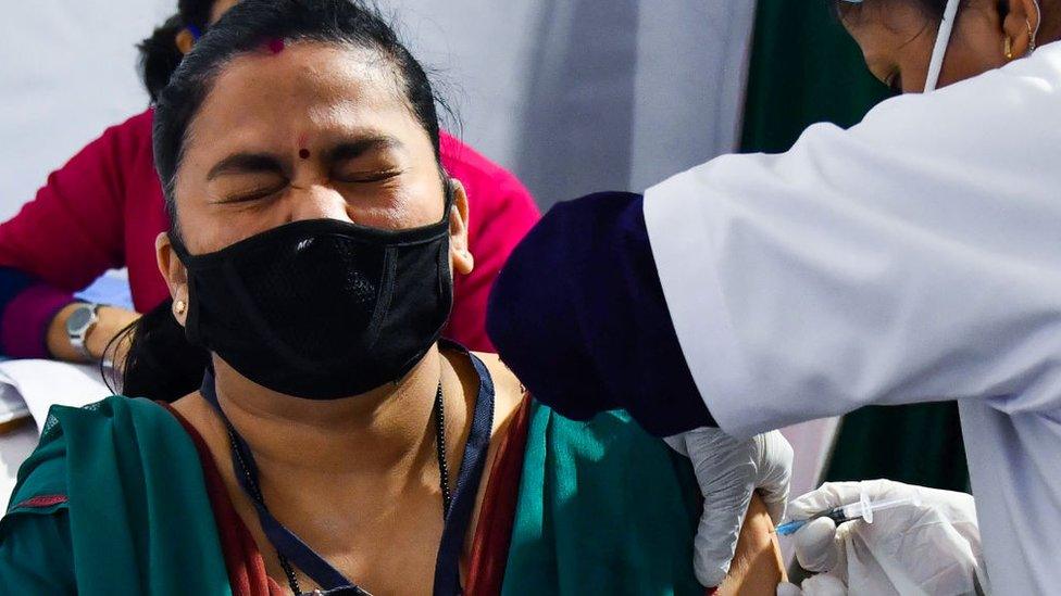 A medical worker inoculates a colleague with a Covid-19 vaccine at a hospital in Guwahati on January 16, 2021.