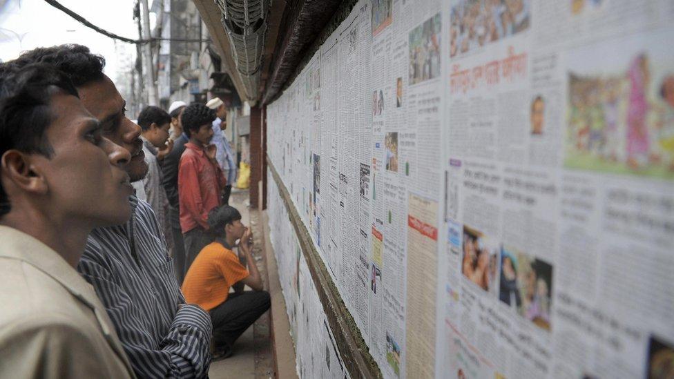 Men reading newspapers in Bangladesh