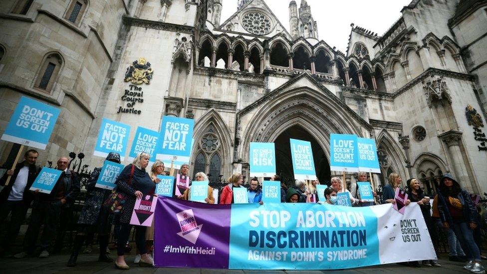 Protesters stand outside the High Court ahead of a case to challenge the Down"s Syndrome abortion laws in London