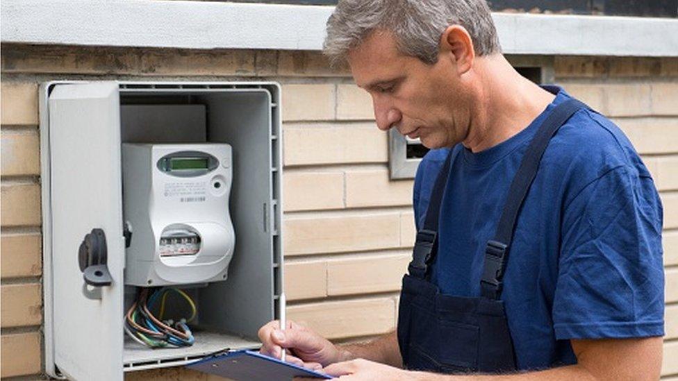 Man checking electric meter