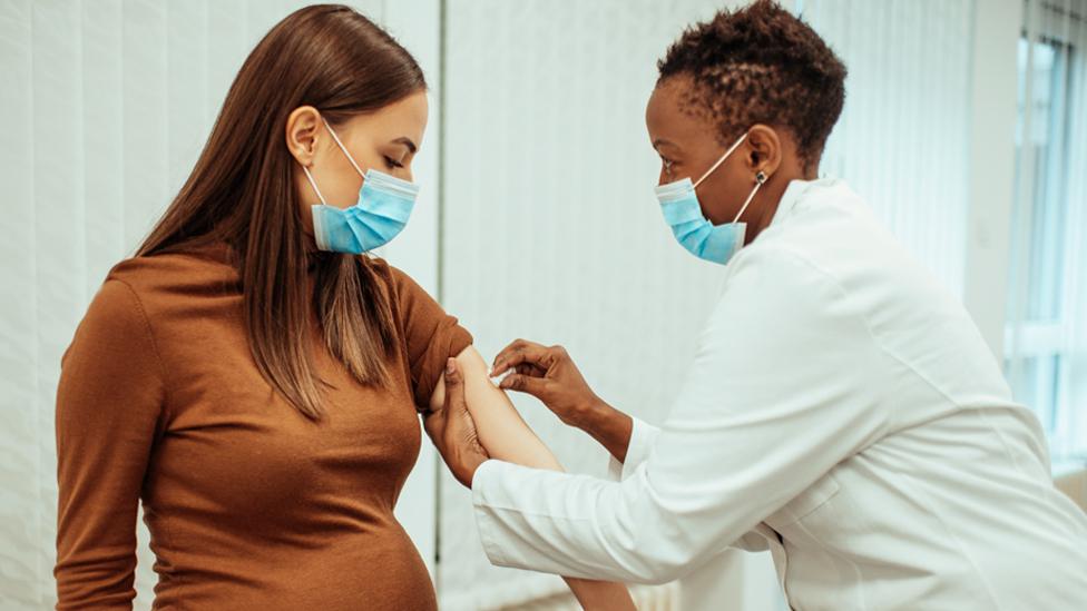 Pregnant woman being vaccinated