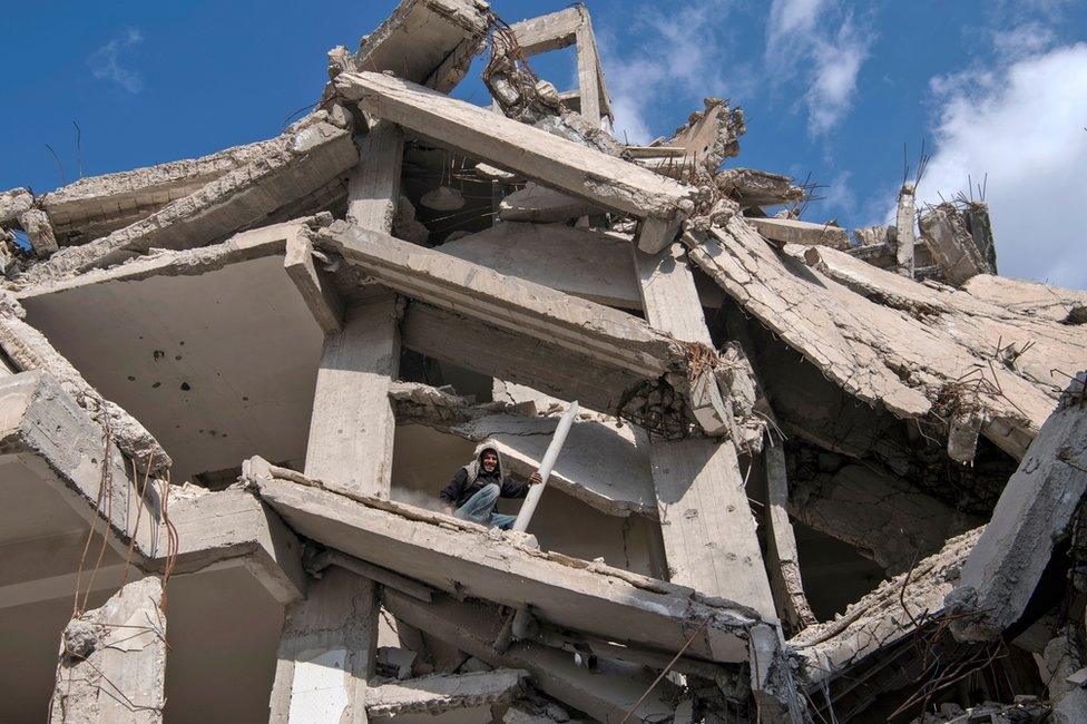 A Syrian man recovers scrap material from destroyed buildings in Raqqa (19 February 2019)