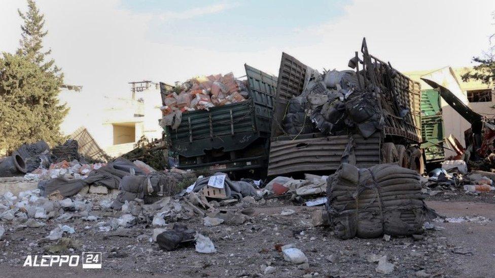 Aftermath of aid convoy attack, showing aid on ground and destroyed lorries