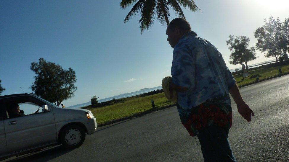 A man walking walking in a street in Nuku'alofa