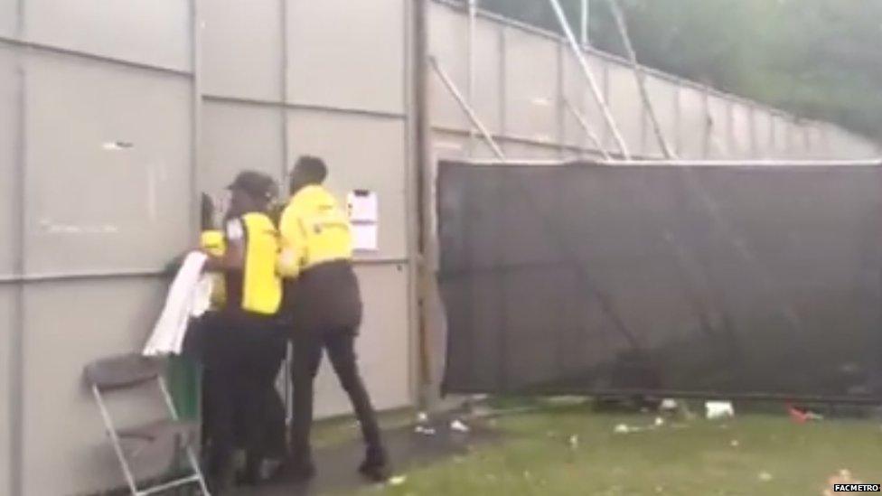 Security guards at a metal gate