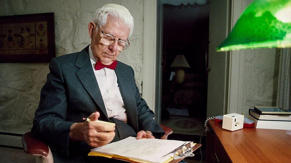 American psychiatrist and professor Dr Aaron Beck makes notes on a clipboard in 1994 image