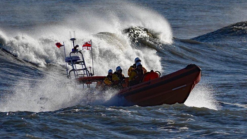 A lifeboat ride among breaking waves