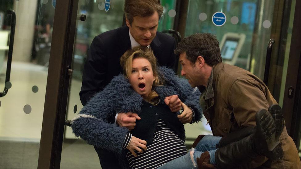 Colin Firth and Patrick Dempsey carry Renee Zellweger in Bridget Jones's Baby