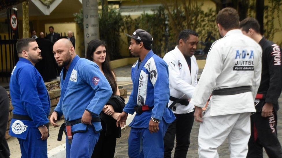 Mourners in Jiu-Jitsu uniforms attend the wake of Leandro Lo on 8 August 2022