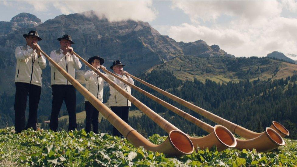 Swiss men on alpenhorns