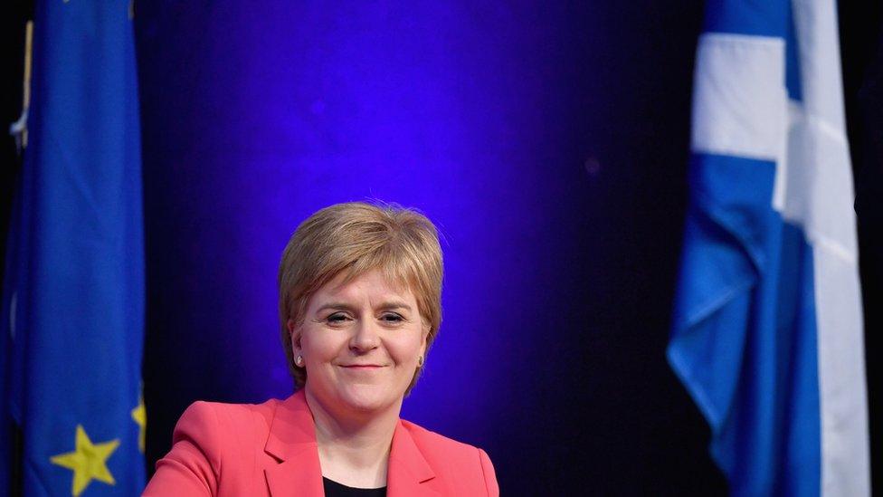 Nicola Sturgeon in front of EU and Scotland flags