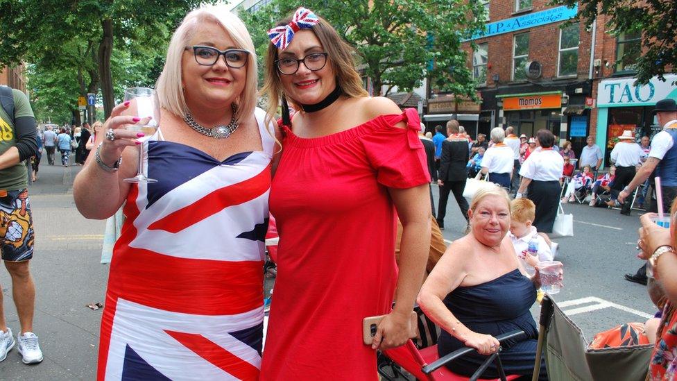 Cousins Daniel and Karla watch the parade. Daniel wears a dress made from a union jack, while Karla had a union jack bow in her hair.