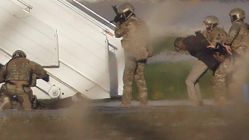 Two hijackers of a Libyan Afriqiyah Airways Airbus A320 surrender to Maltese military on the runway at Malta Airport, December 23, 2016.