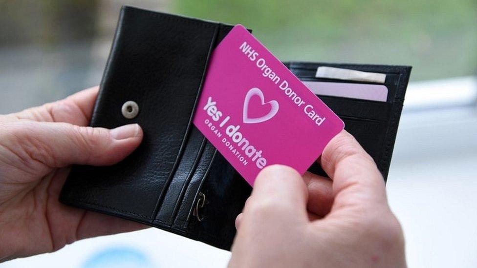 Man holding organ donation card