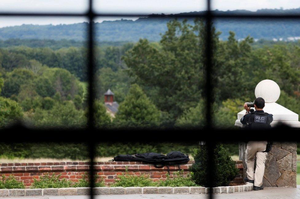 Secret Service scan the horizon outside a room where Trump holds a meeting