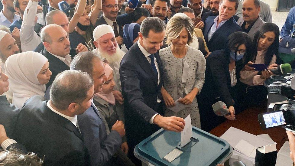 Bashar al-Assad and his wife Asma vote in Syria's presidential election in Douma, near Damascus, on 26 May 2021