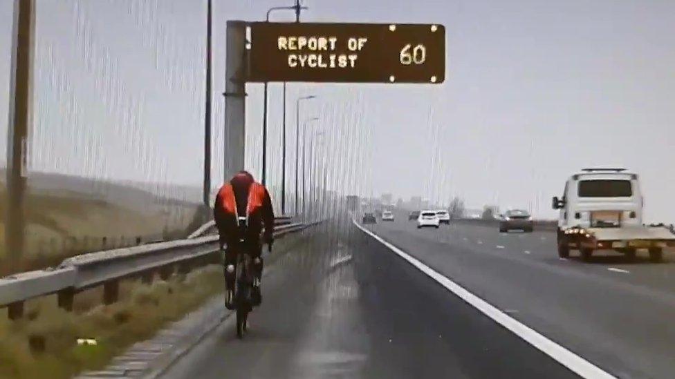 A cyclist on the motorway